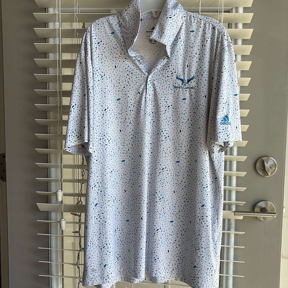 Men’s Adidas Hawkes landing white polo designed with golf pins.